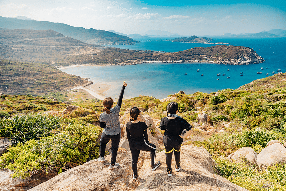 Group of American expats standing on a cliff overlooking the ocean