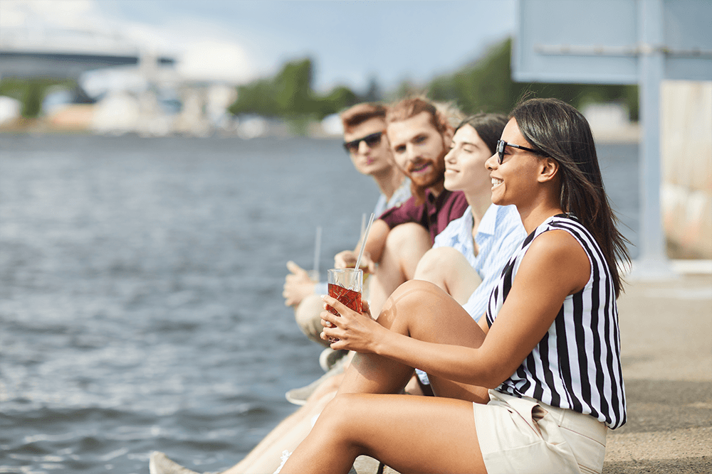 Americans abroad sitting on dock, laughing, talking about 2020 election votes