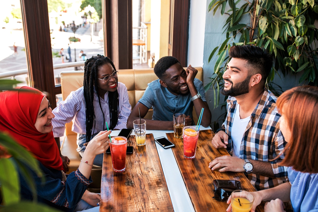 A diverse group of international residents socializing at a café.