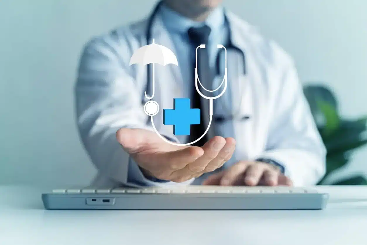 Physician in white coat holds out hand with umbrella, stethoscope and medical cross icon overlay